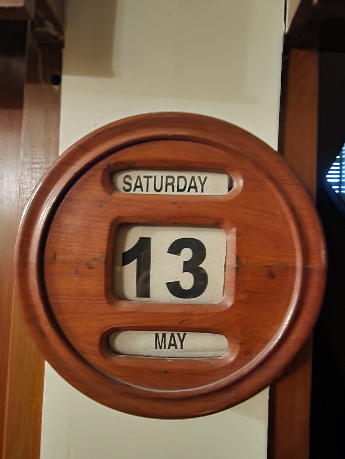 A wooden wall calendar with movable blocks