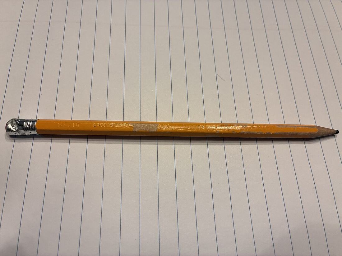 A pencil resting on a notebook