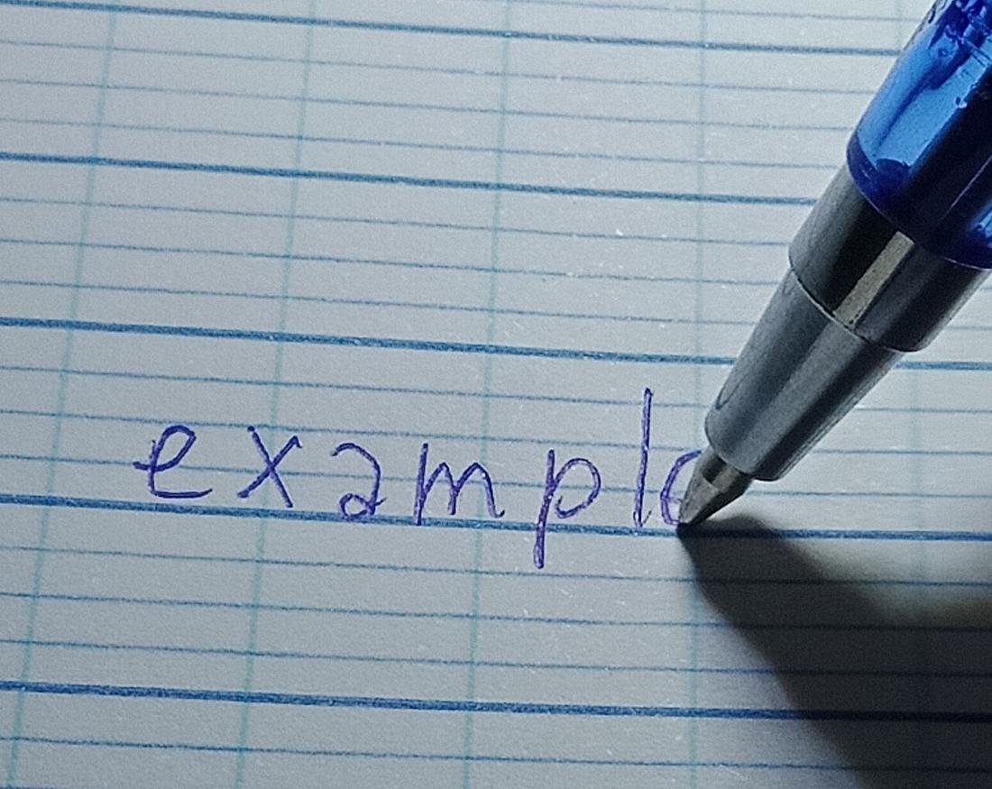 A pen writing on paper